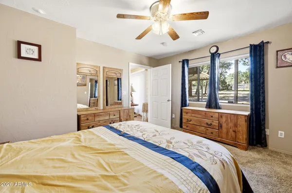 a bedroom with a bed and a dresser