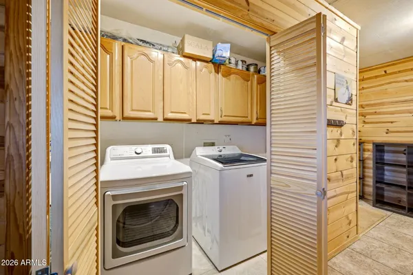 a bedroom with a bed window and flat screen tv