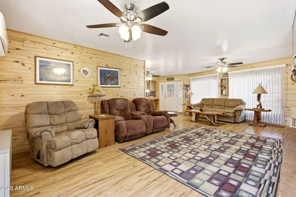 a open kitchen with stainless steel appliances granite countertop a sink dishwasher and white cabinets with wooden floor