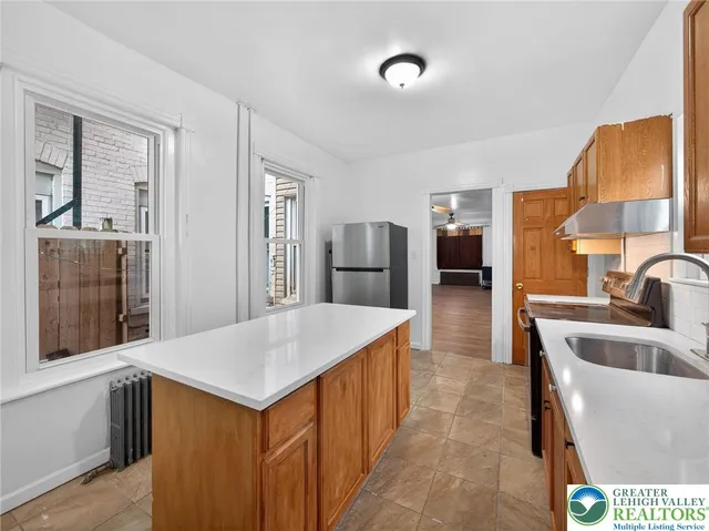 a living room with stainless steel appliances kitchen island granite countertop furniture and a kitchen view