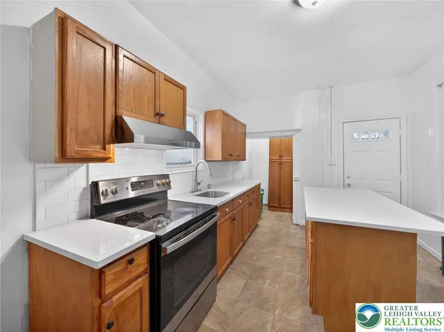 a kitchen with a stove and a refrigerator