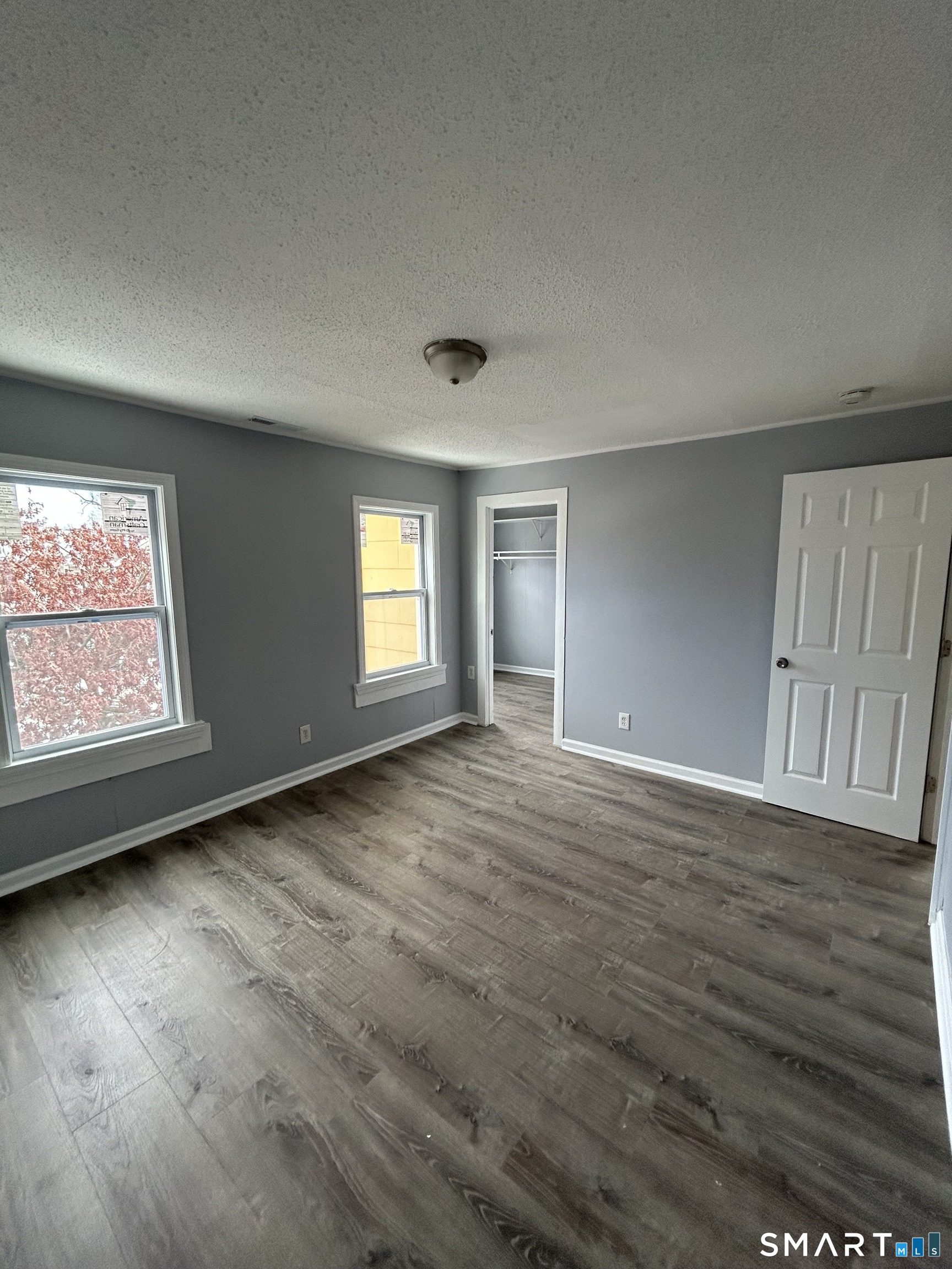 18 Wilson Street, Unit 2 New Haven, CT 06519 - Photo 7 of 17 an empty room with wooden floor and windows