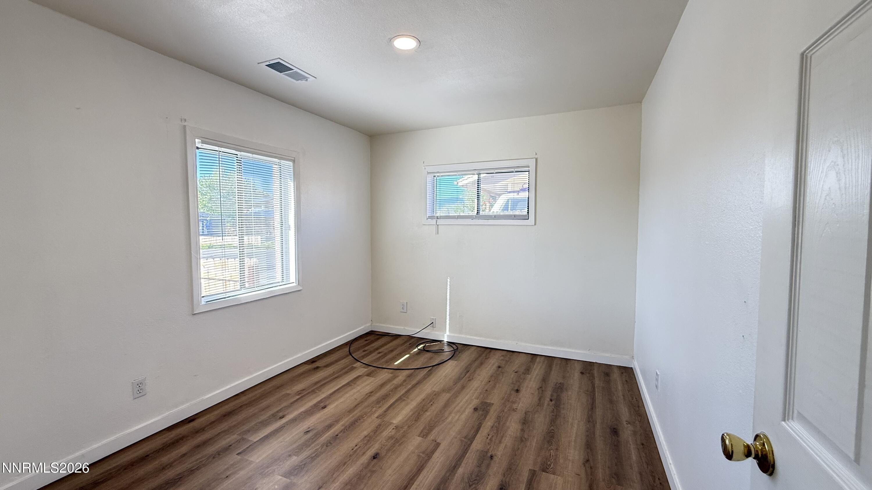 1939 Wilder Street Reno, NV 89512 - Photo 11 of 28 wooden floor in an empty room with a window