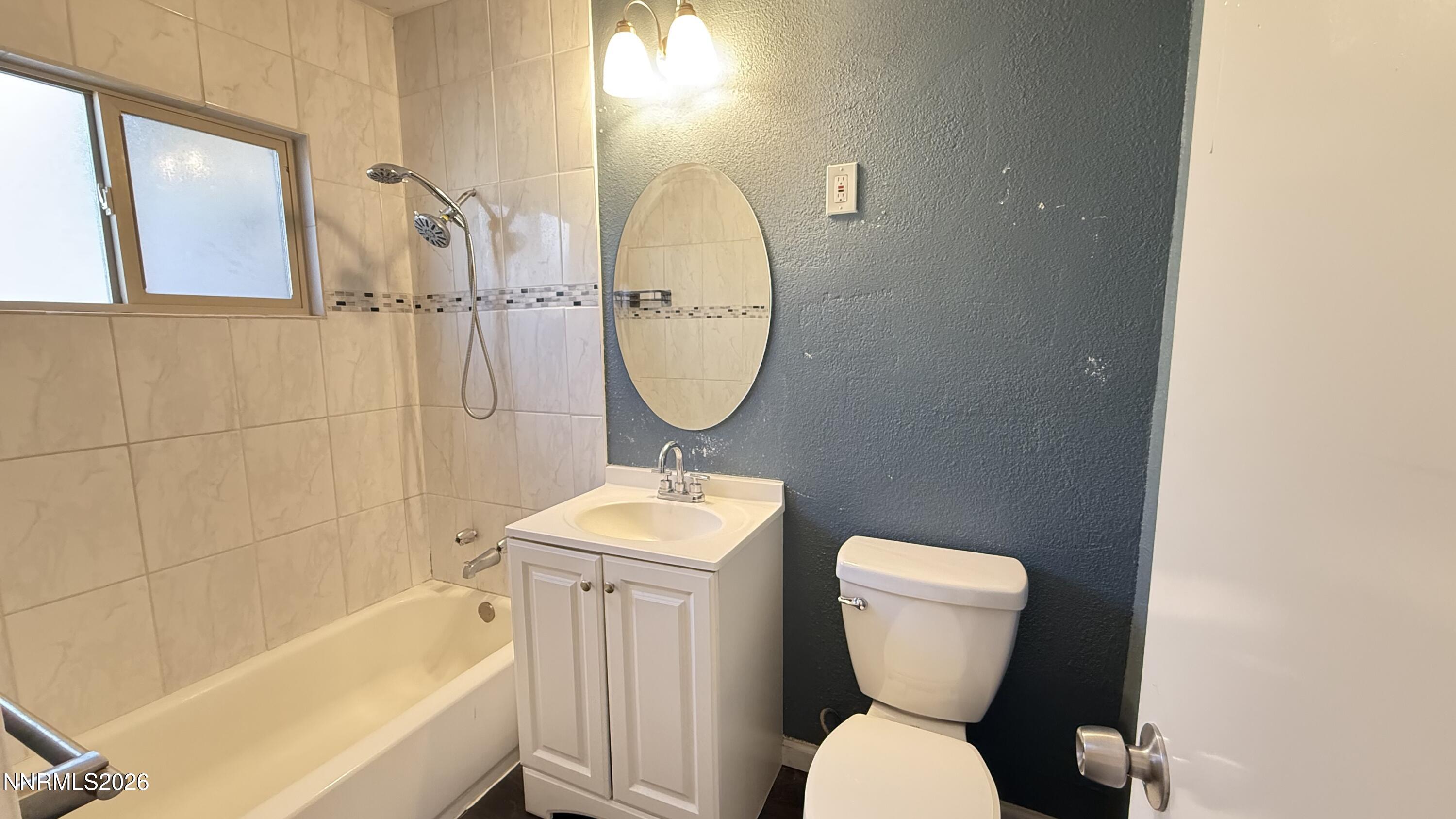 1939 Wilder Street Reno, NV 89512 - Photo 13 of 28 a bathroom with a toilet sink and mirror