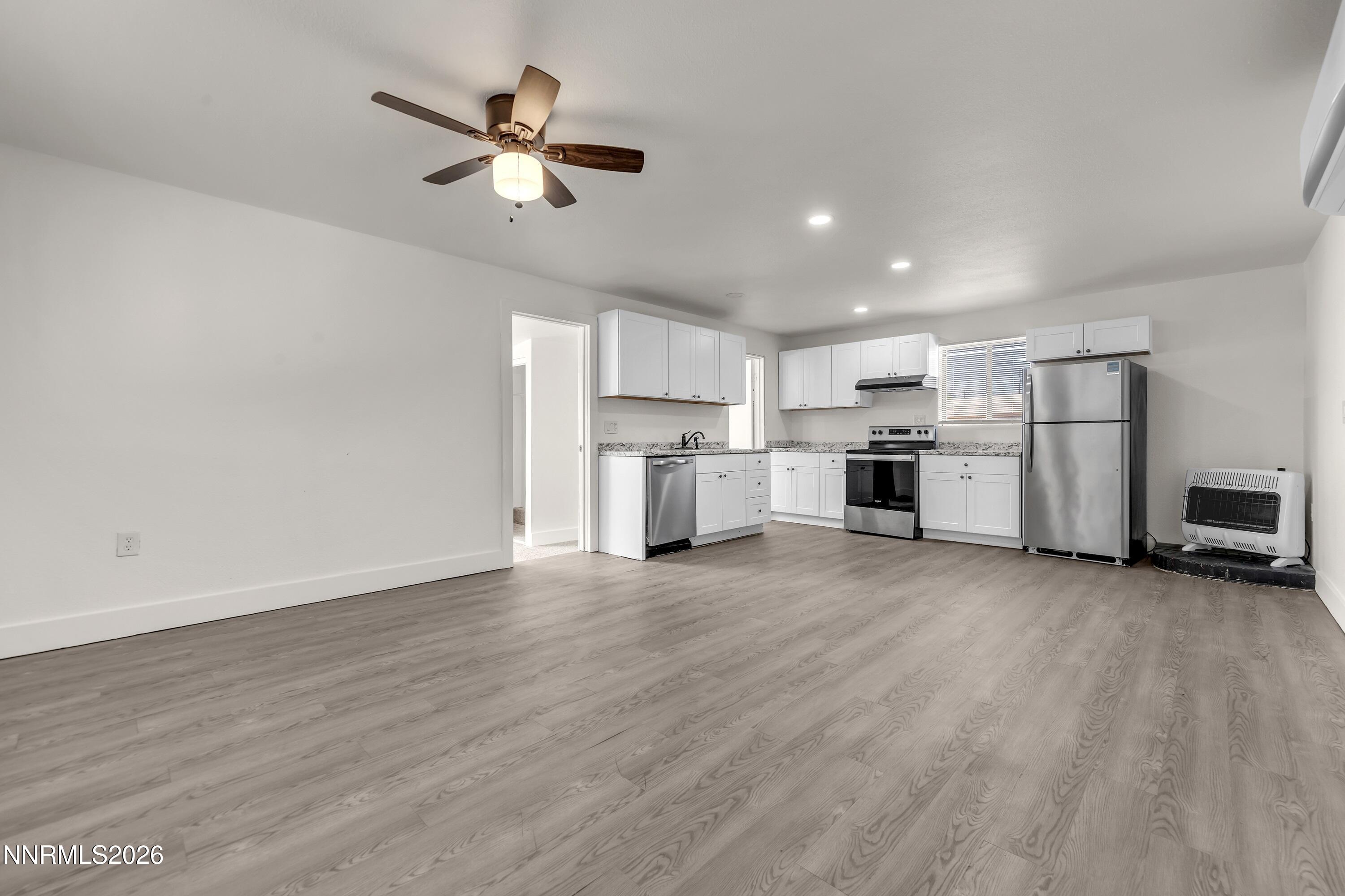 1939 Wilder Street Reno, NV 89512 - Photo 21 of 28 a view of a kitchen with refrigerator and microwave