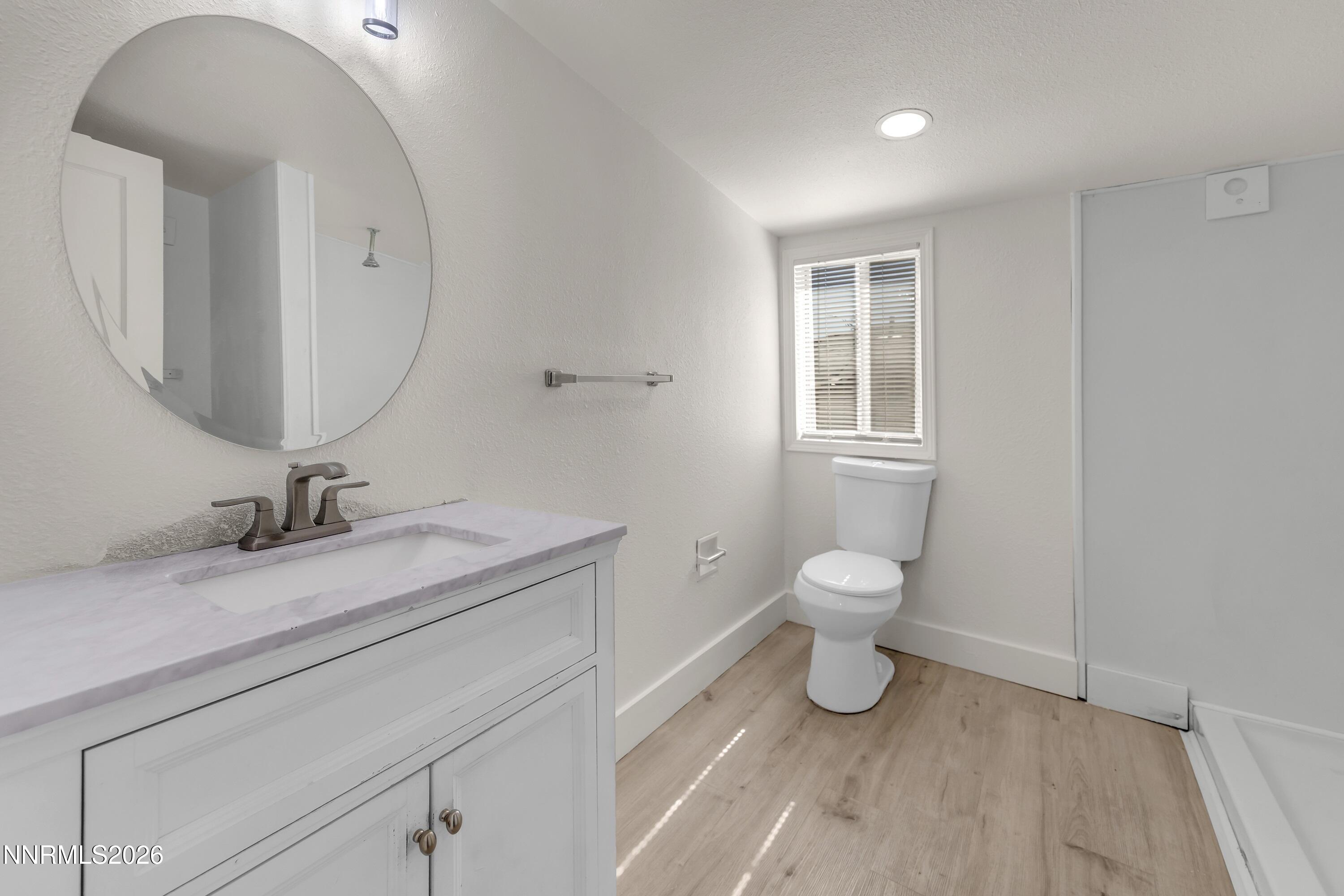 1939 Wilder Street Reno, NV 89512 - Photo 27 of 28 a bathroom with a toilet sink and mirror