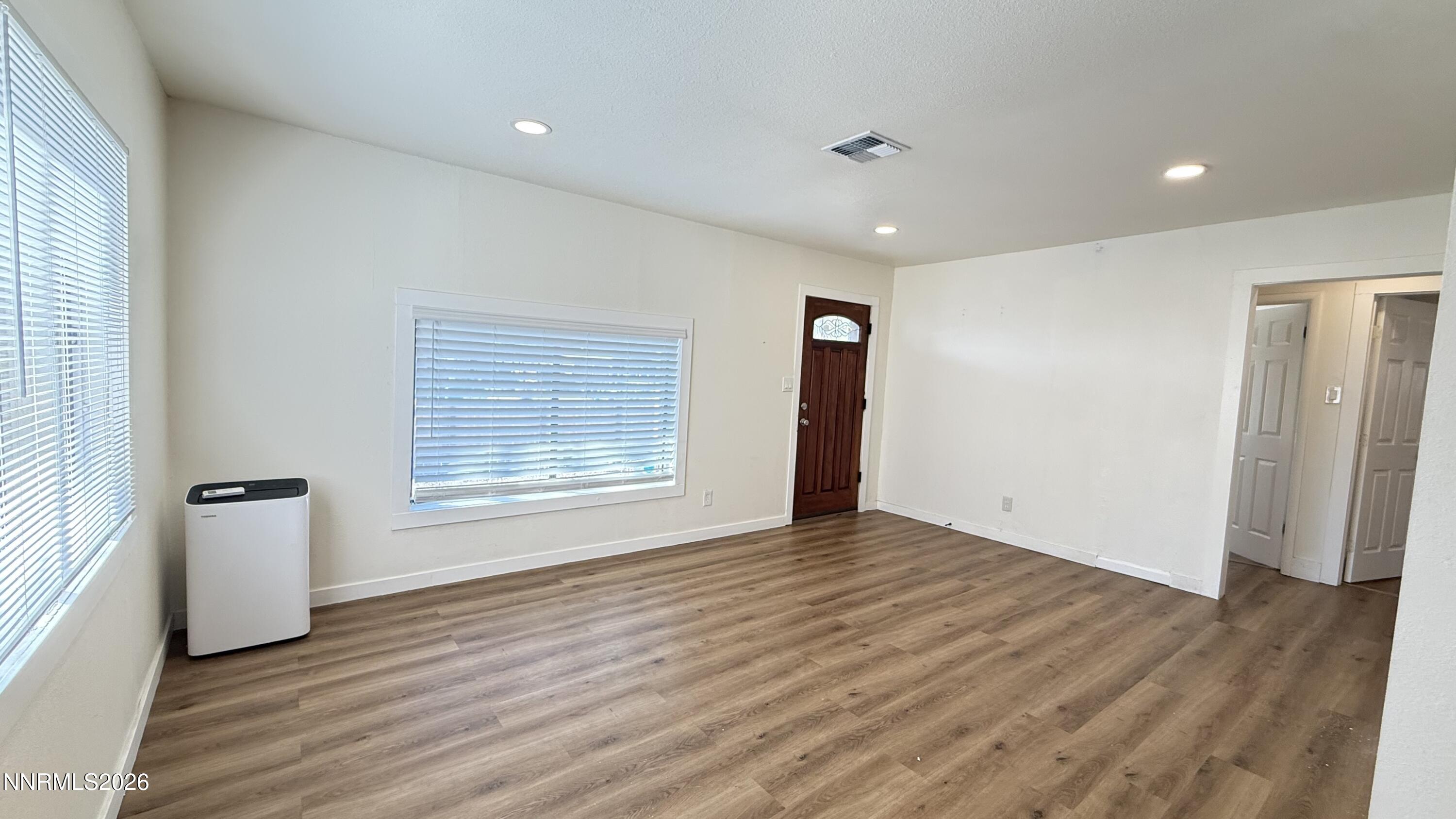 1939 Wilder Street Reno, NV 89512 - Photo 10 of 28 a view of an empty room with wooden floor and a window
