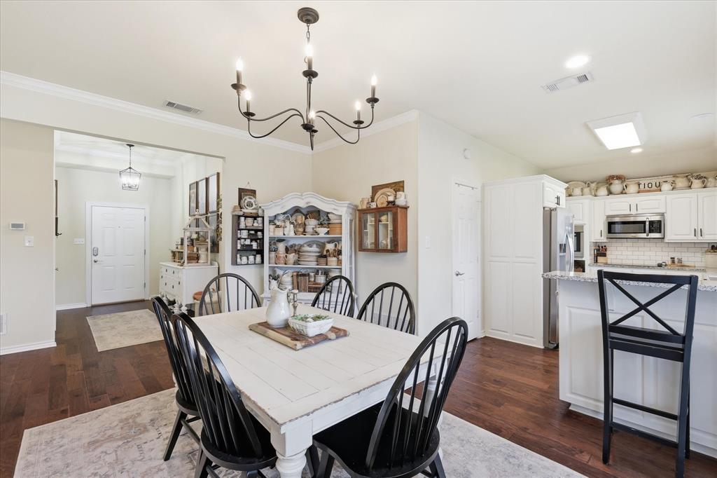 202 Colonial Heights Sanger, TX 76266 - Photo 9 of 27 a view of a dining room with furniture and wooden floor