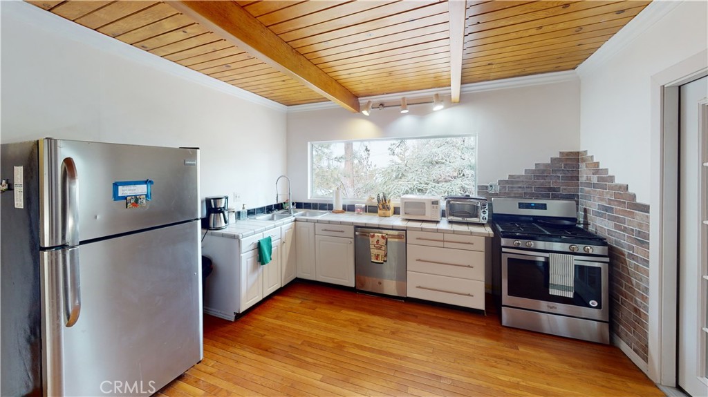 5218 Desert View Drive Wrightwood, CA 92397 - Photo 11 of 50 Kitchen, oipen beam & wood flooring