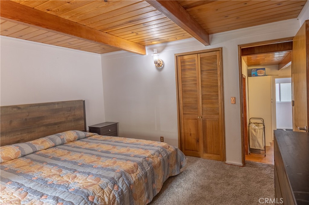 5218 Desert View Drive Wrightwood, CA 92397 - Photo 20 of 50 a bedroom with a bed and wooden floor