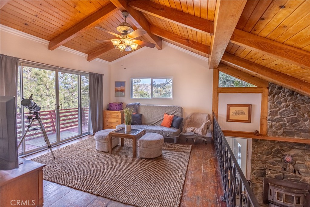 5218 Desert View Drive Wrightwood, CA 92397 - Photo 26 of 50 a living room with furniture and large windows