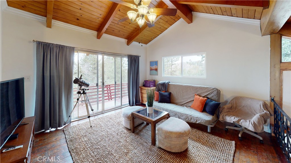 5218 Desert View Drive Wrightwood, CA 92397 - Photo 28 of 50 a living room with furniture a flat screen tv and a large window