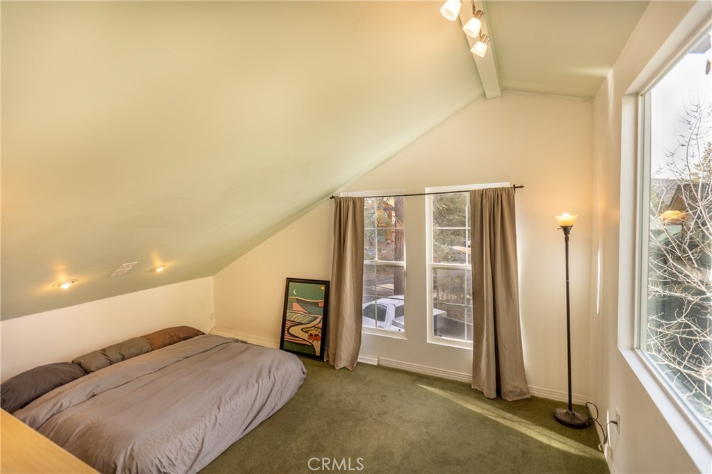 5218 Desert View Drive Wrightwood, CA 92397 - Photo 41 of 50 a spacious bedroom with a bed and a window