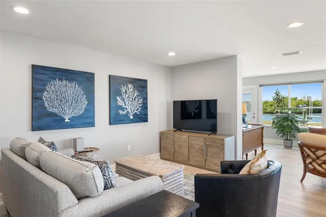 a living room with furniture and kitchen view