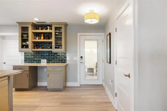 a kitchen with kitchen island cabinets a sink a center island stainless steel appliances and cabinets