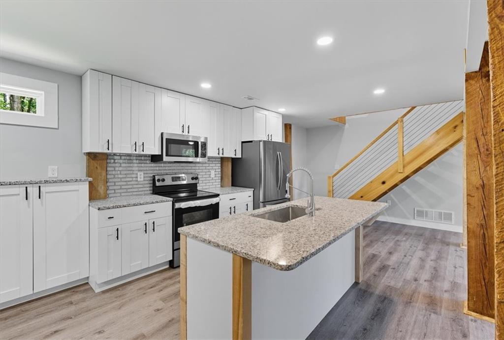 96 Collins Road Rome, GA 30161 - Photo 19 of 57 a kitchen with a sink microwave and refrigerator