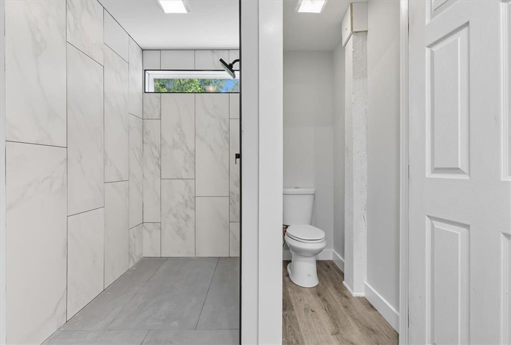 96 Collins Road Rome, GA 30161 - Photo 28 of 57 a bathroom with a granite countertop toilet and a shower