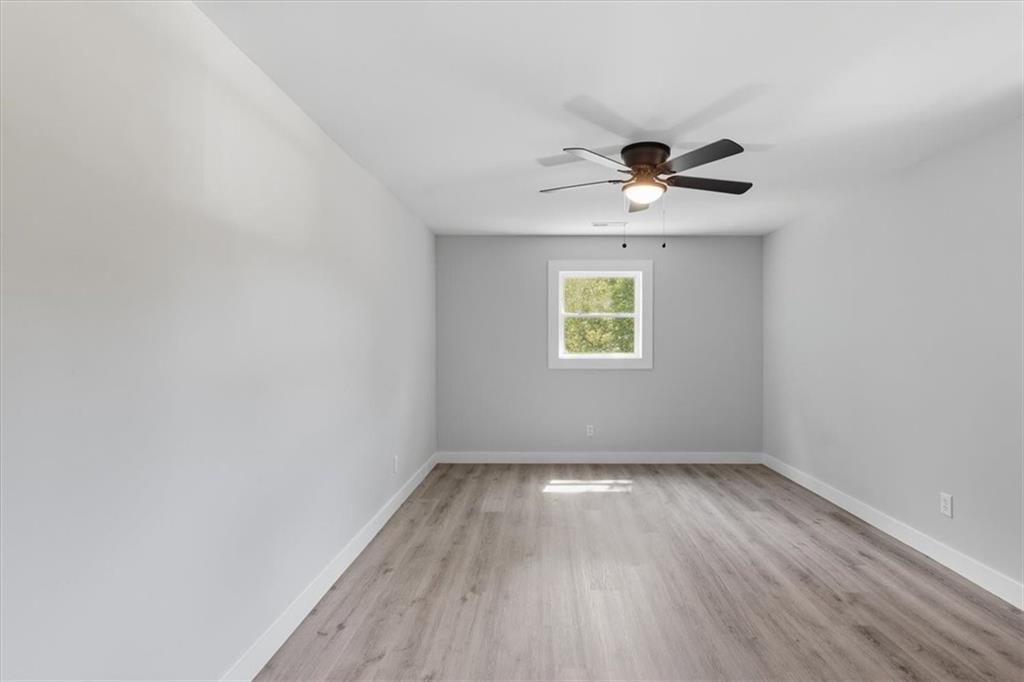 96 Collins Road Rome, GA 30161 - Photo 36 of 57 an empty room with a window and a ceiling fan