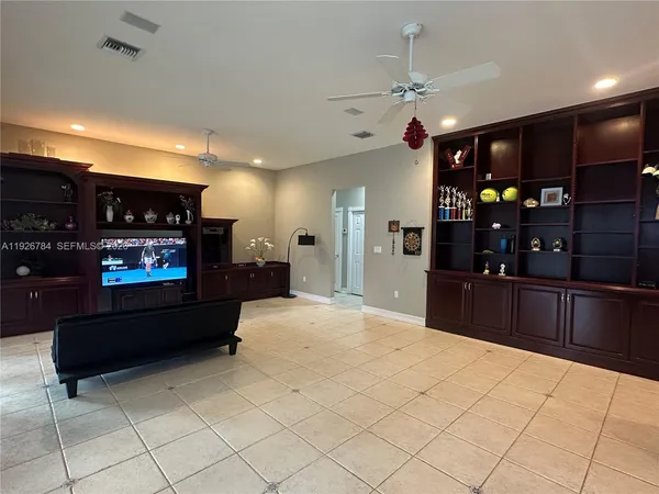 a large kitchen with stainless steel appliances kitchen island granite countertop a refrigerator and a stove