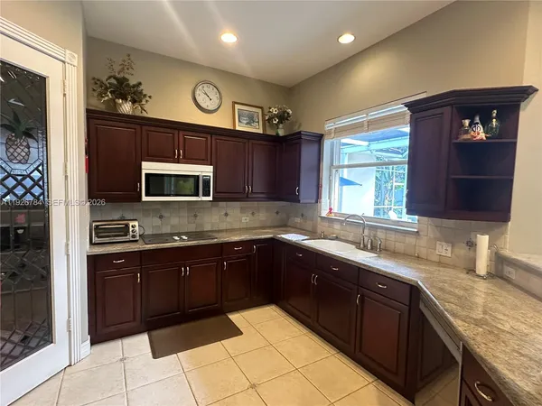 a kitchen with stainless steel appliances granite countertop a sink and cabinets