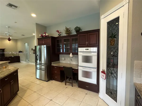 a kitchen with refrigerator and cabinets