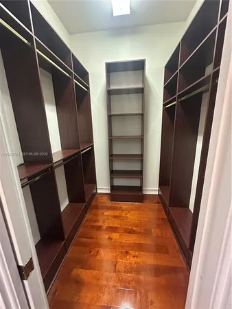a view of walk in closet with empty racks