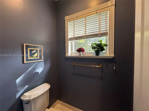 a white toilet sitting next to a window