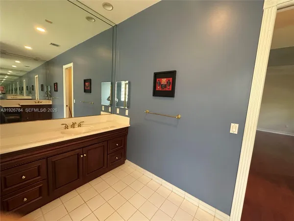 a bathroom with a sink a vanity and a large mirror