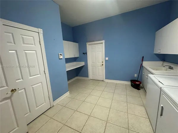 a view of utility room and bedroom