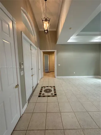 a very nice looking hallway with a chandelier