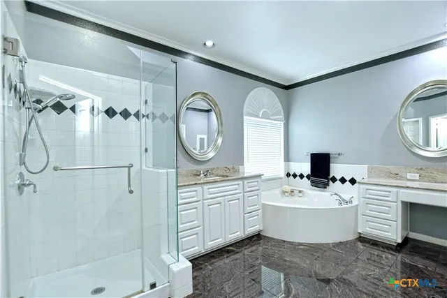 a kitchen with a sink white cabinets and stainless steel appliances