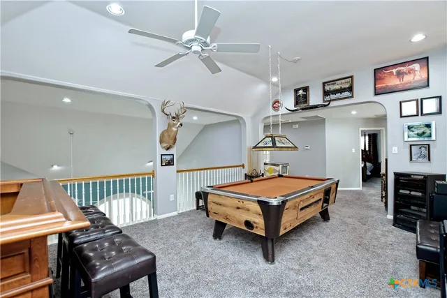 a living room with furniture fireplace and a large window