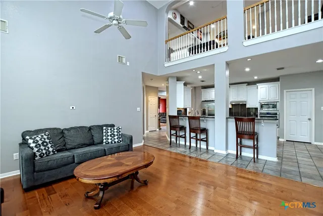 a living room with furniture and a dining table with kitchen view