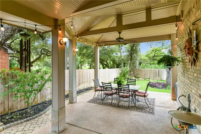 a view of a patio with a table chairs and a backyard