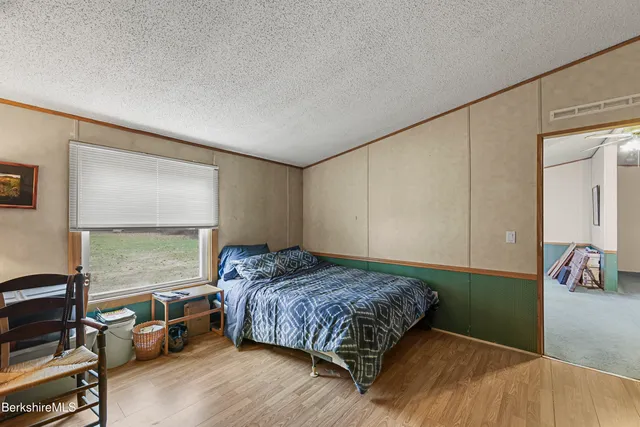 a picture of a big yard with table and chair and large trees