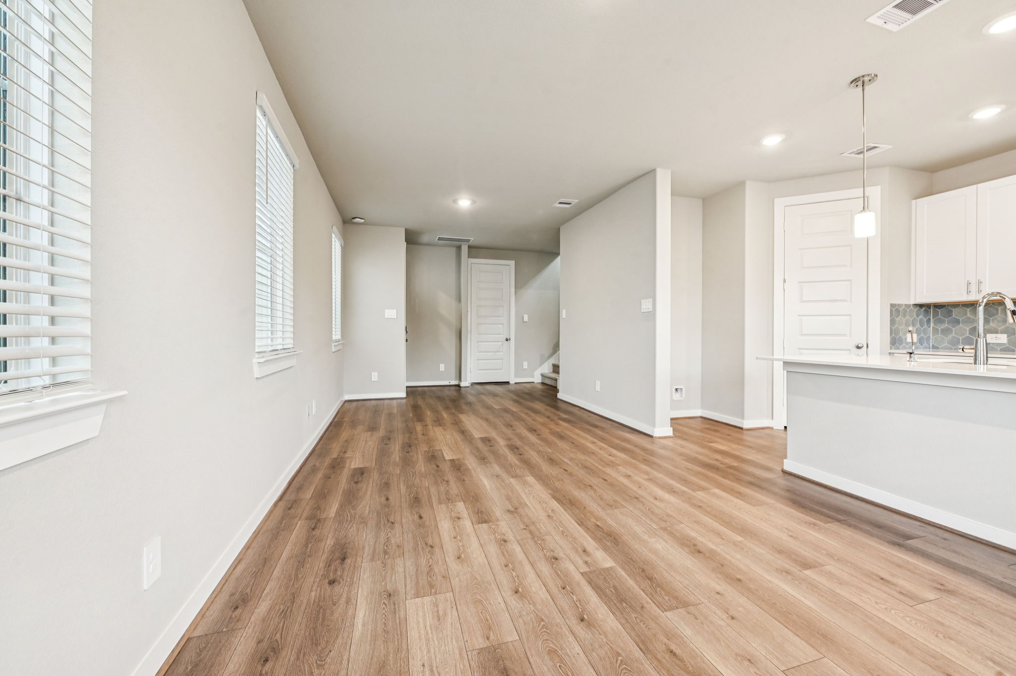 10008 Rustic Charm Street Houston, TX 77080 - Photo 3 of 30 a view of empty room with wooden floor and kitchen