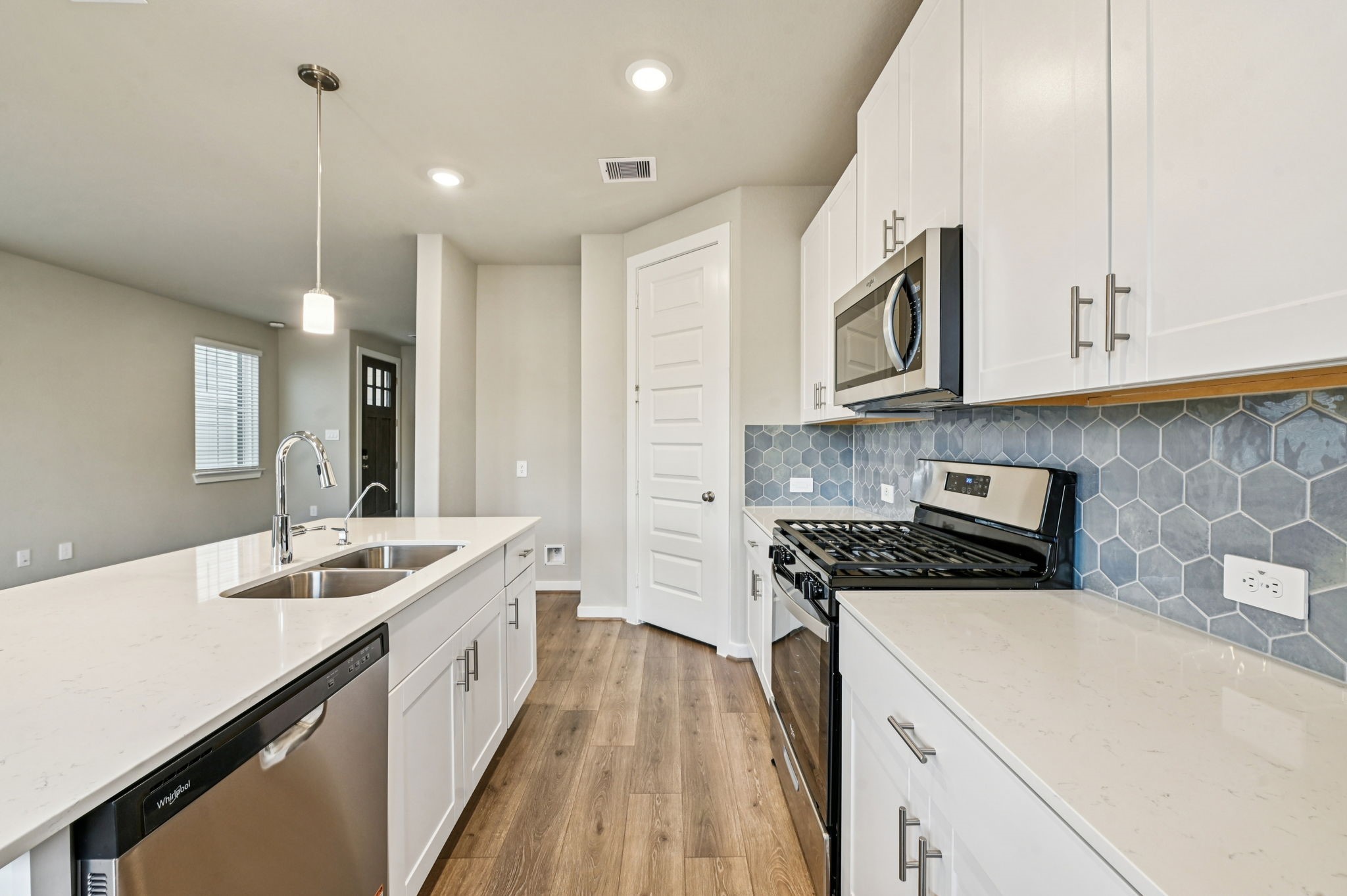 10008 Rustic Charm Street Houston, TX 77080 - Photo 6 of 30 a kitchen with a sink a stove and cabinets