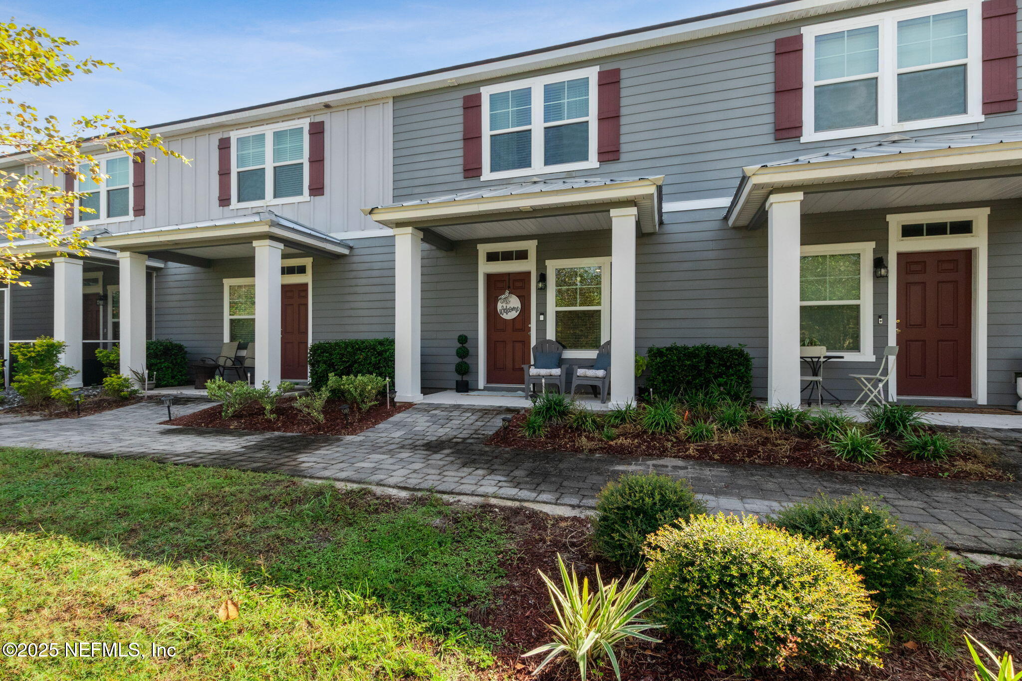 a front view of a house with garden and porch