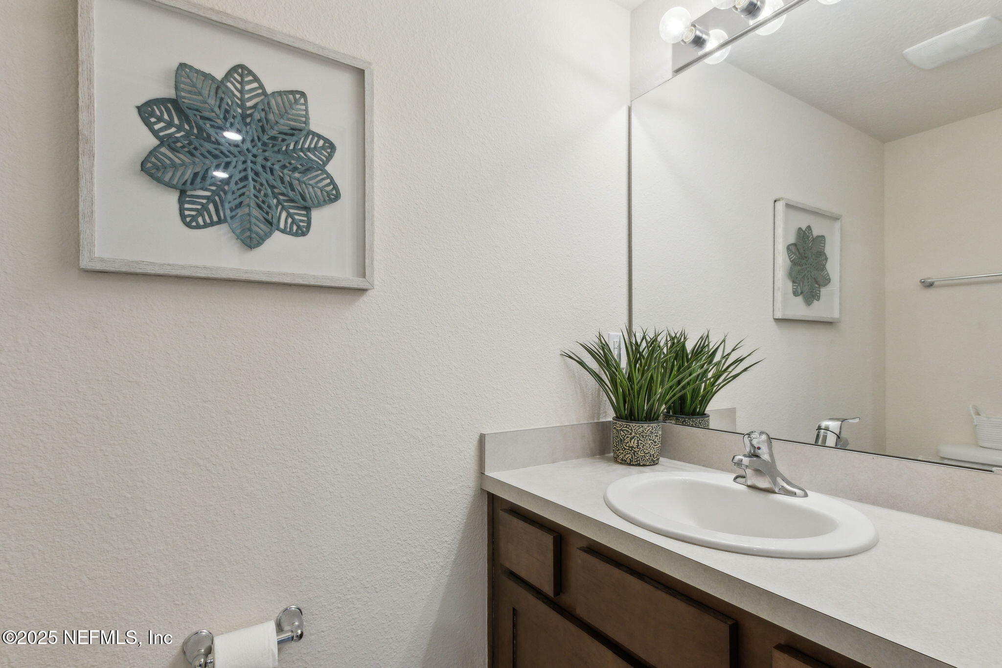 86440 Mainline Road Yulee, FL 32097 - Photo 12 of 36 a bathroom with a sink and a mirror