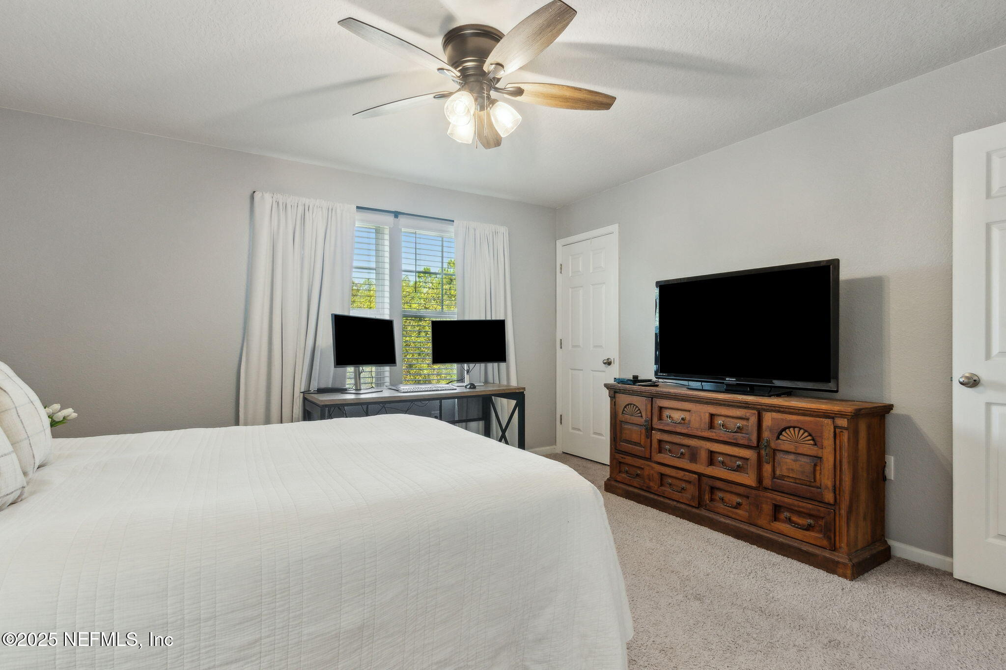 86440 Mainline Road Yulee, FL 32097 - Photo 14 of 36 a bedroom with a bed and a flat screen tv
