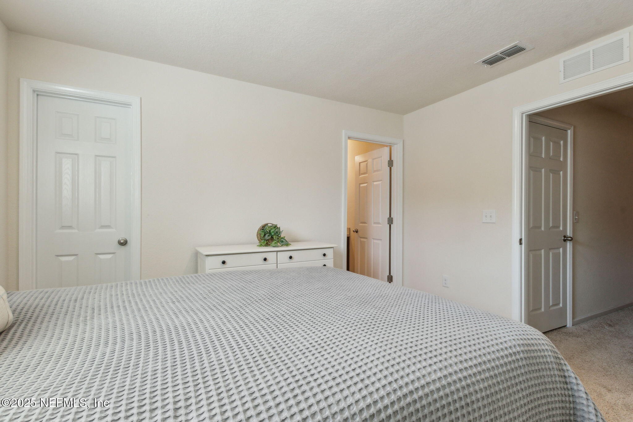 86440 Mainline Road Yulee, FL 32097 - Photo 18 of 36 a bedroom with a bed and white cabinets