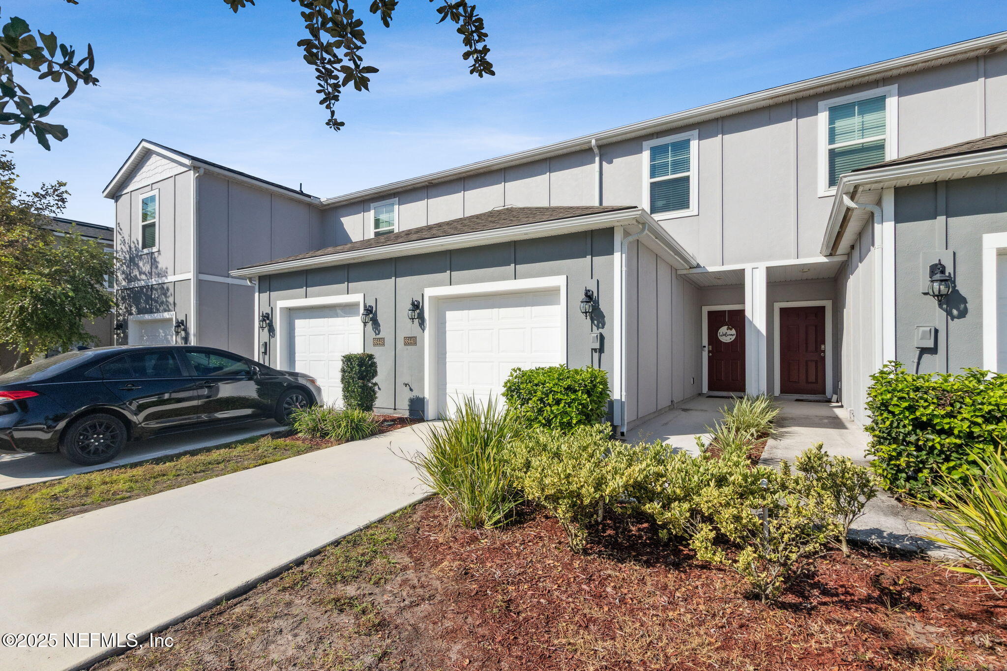 86440 Mainline Road Yulee, FL 32097 - Photo 24 of 36 front view of a house with a small yard