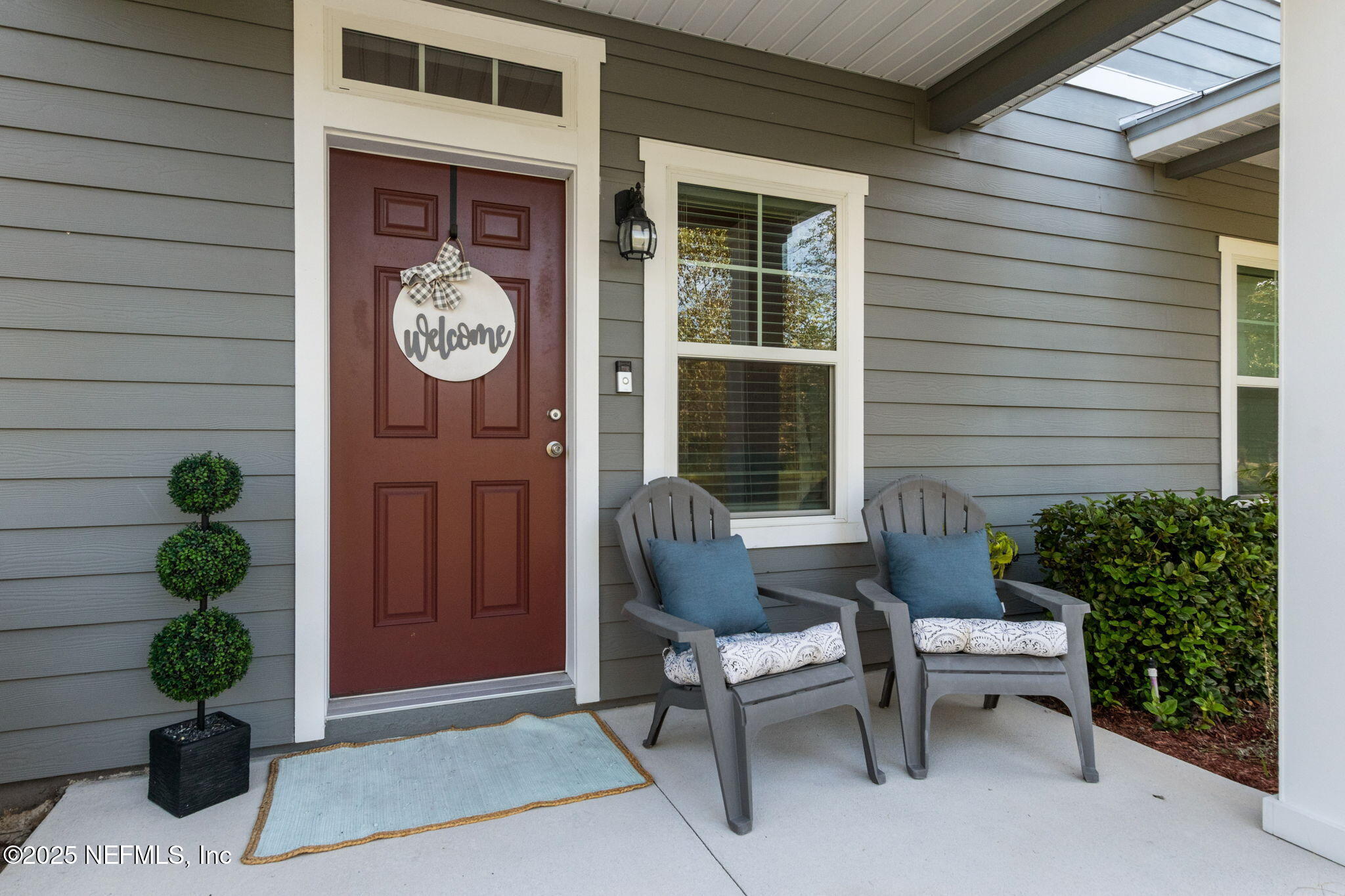 86440 Mainline Road Yulee, FL 32097 - Photo 3 of 36 a view of a house with lounge chair and a potted plant