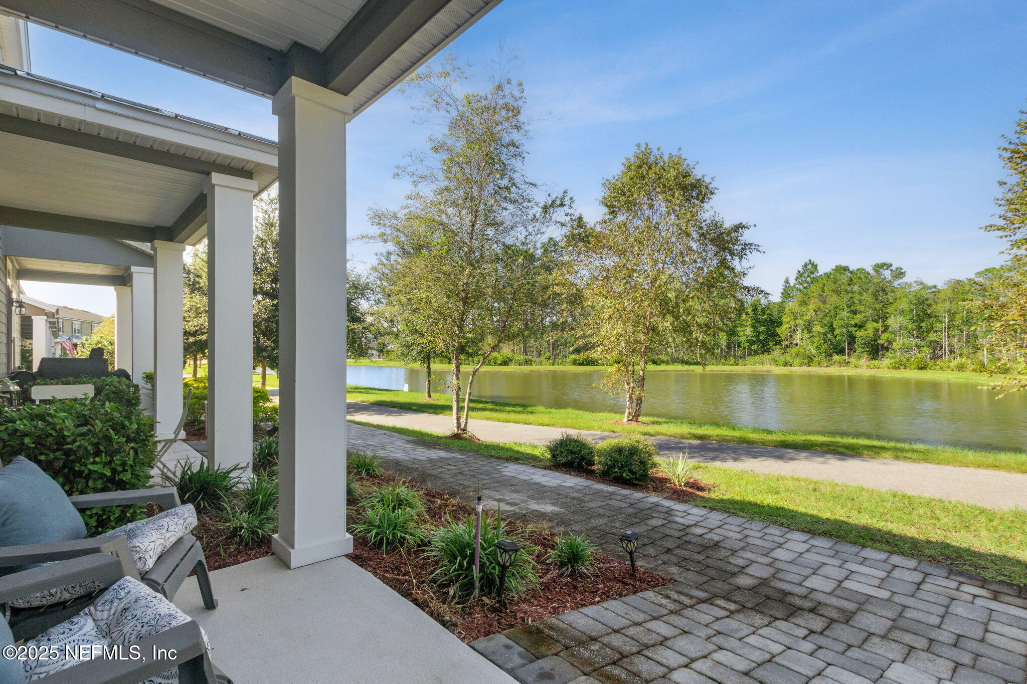 86440 Mainline Road Yulee, FL 32097 - Photo 4 of 36 a view of a backyard with plants and lake view