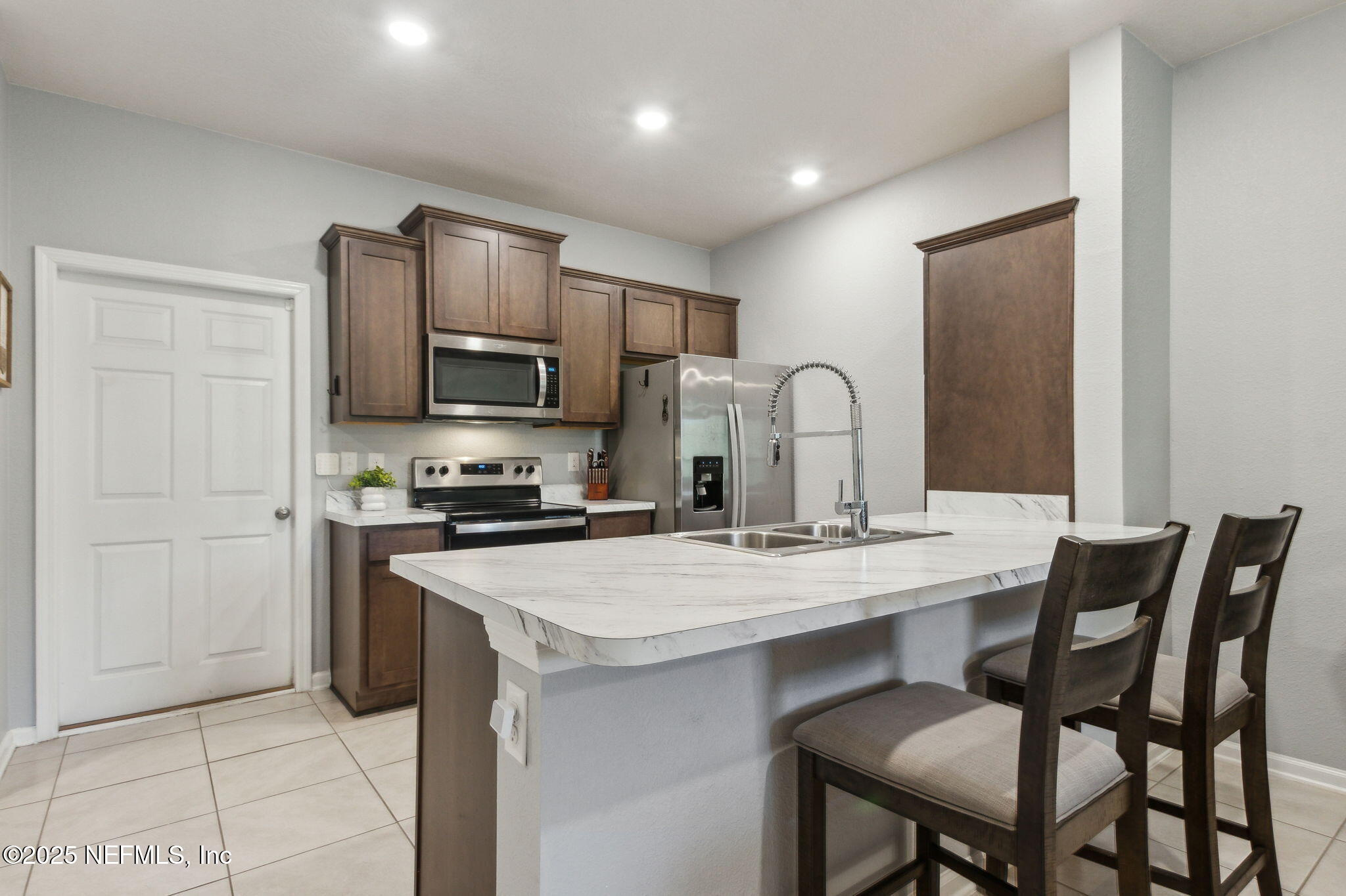 86440 Mainline Road Yulee, FL 32097 - Photo 9 of 36 a kitchen with a stove a sink and a refrigerator