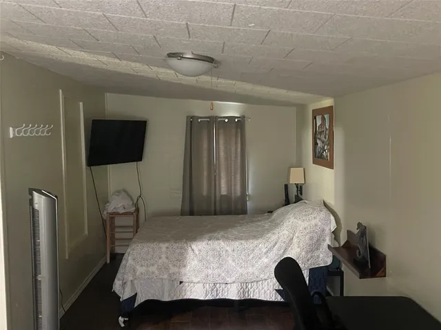 a hallway with couches and wooden floor