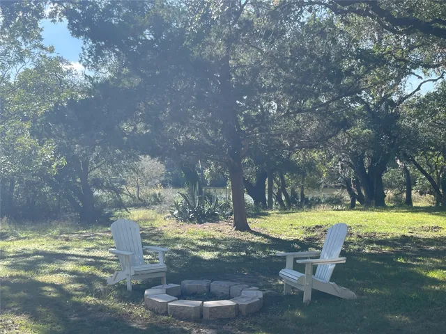 a view of a yard with swimming pool