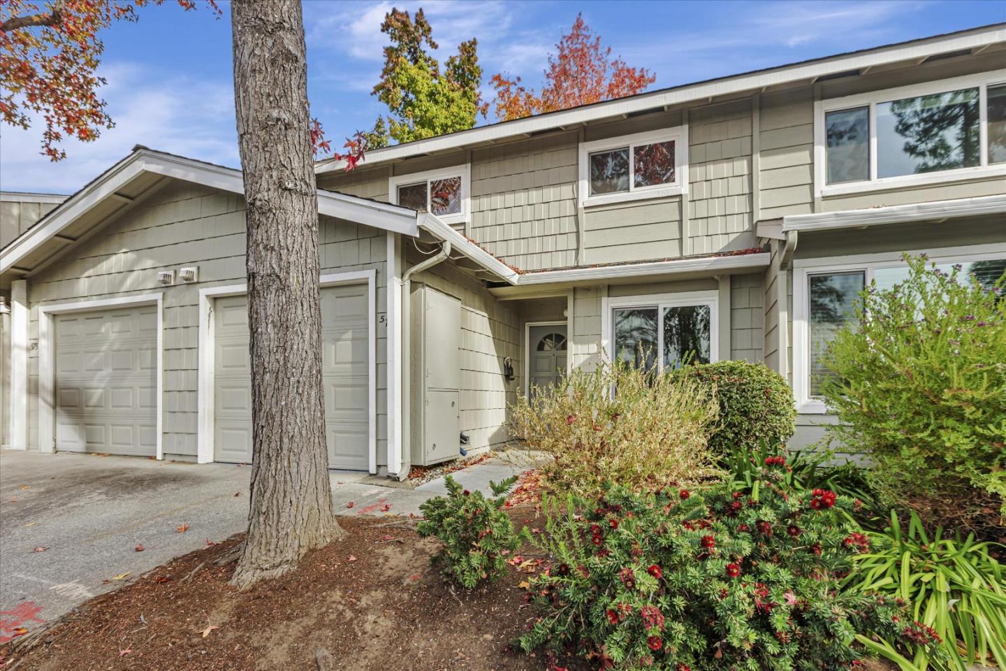 a front view of a house with a garden