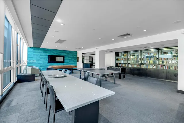 a view of a dining room with furniture and a floor to ceiling window