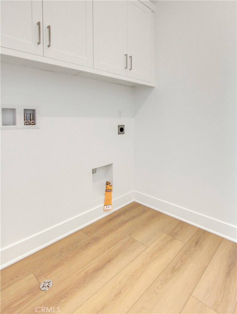 230 Sora Irvine, CA 92618 - Photo 22 of 52 a view of a kitchen with white cabinets and a wooden floor